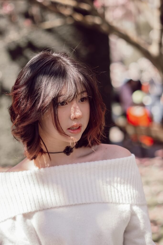 Young woman with stylish hair and off-the-shoulder top